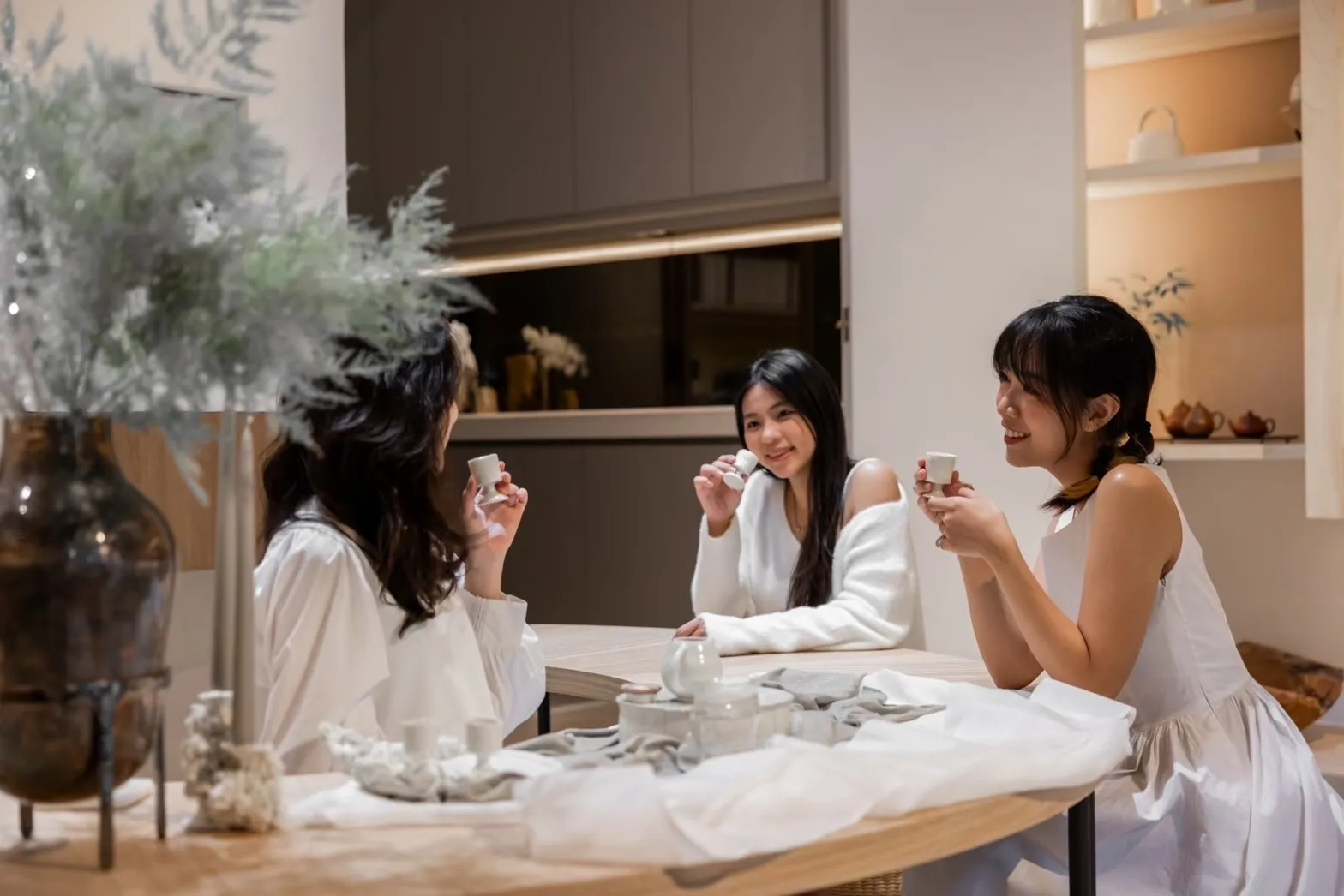 A trio of people enjoying tea